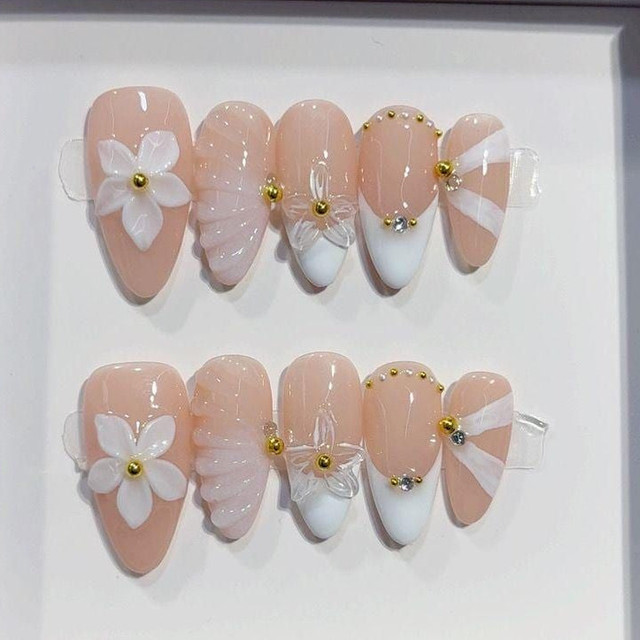 Set of handmade nail art designs in a box labeled 'Handmade Nail by professional nail designer'.